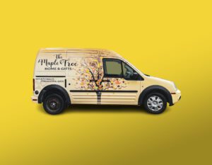 Yellow Ford Transit Van With A Maple Tree Decal On The Side.