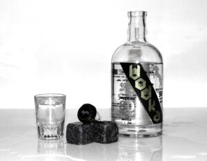 Black And White Photo Of A Bottle Of Vodka Labeled "40" On A Table